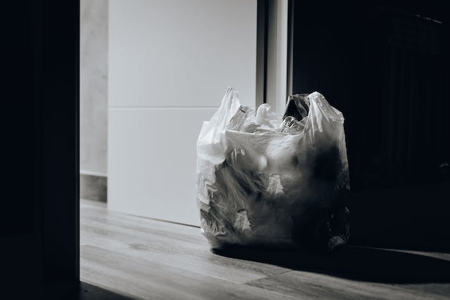 a small plastic garbage bag left in a doorway