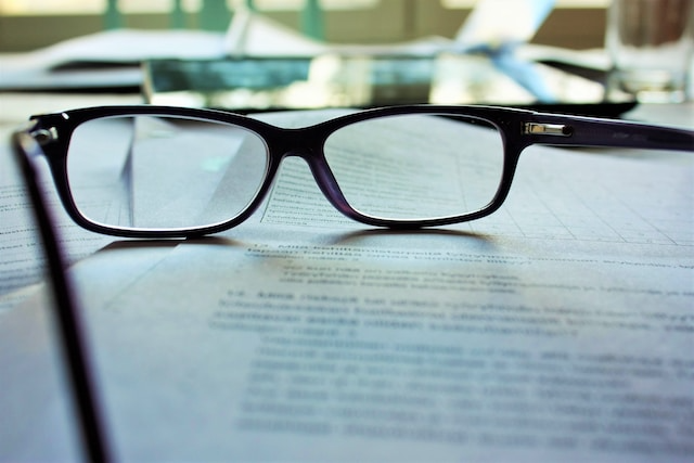 A pair of glasses on top of a paper